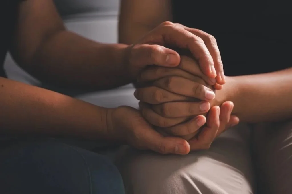 Supportive hands representing compassionate coaching